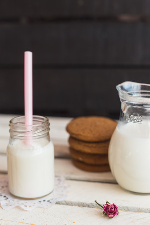 Rustic home made tasty  cookies on the wooden background with milkの写真素材
