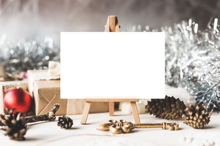 Stylish brending mockup to display your artworks. Cute vintage christmas new year gifts mock up on wooden background.の写真素材