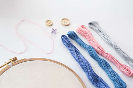 Flat lay top view photo of a mockup with embroidery hoop and llilac flowers.