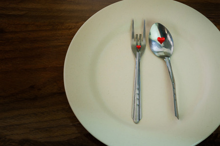Utensils placed on a white plate.