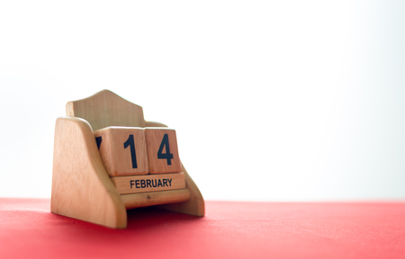 valentine's day concept. wooden calendar 14 February with soft-focus and over light in the backgroundの写真素材