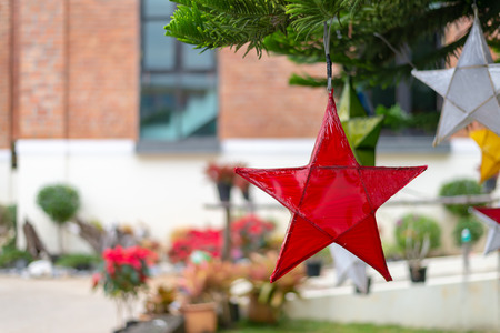 paper lamp on christmas tree decoration with soft-focus and over light in the backgroundの写真素材