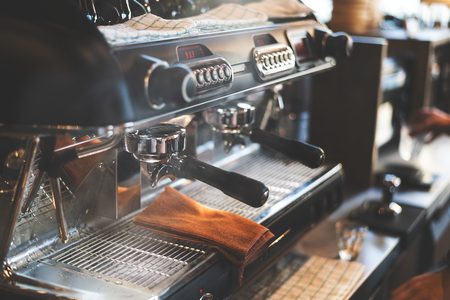closeup coffee machine with soft-focus and over light in the backgroundの写真素材