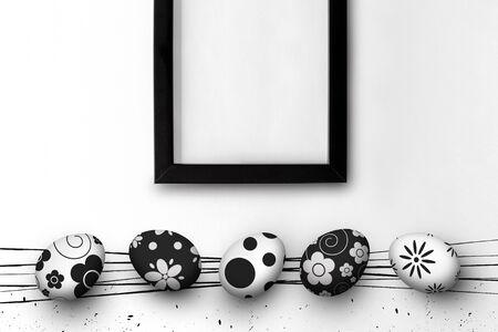 easter eggs and blank picture frame on white table background. top view