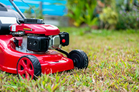 close up lawn mower in the park on the grass. over light [blur and select focus backgroundの写真素材