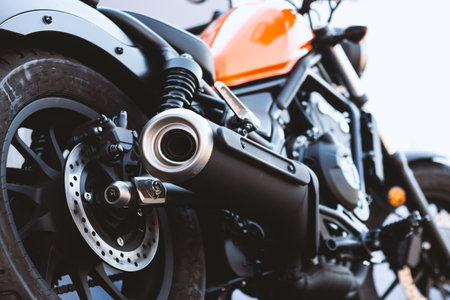 closeup motorcycle exhaust pipe with soft-focus and over light in the backgroundの写真素材