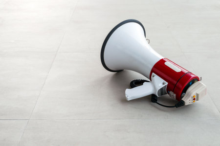 old megaphone on cement floor with soft-focus and over light in the backgroundの写真素材