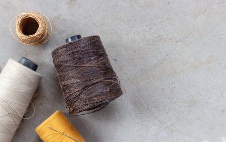 craft and DIY concept. sewing threads on cement floor. top viewの写真素材