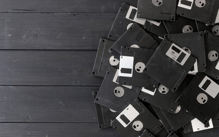 blank floppy disks on wood backgroundの写真素材