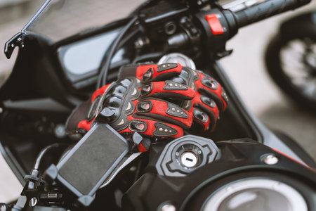 closeup driving gloves on bigbike with soft-focus and over light in the backgroundの写真素材