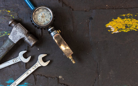closeup set of tools for motorbike repair on dark background. top view