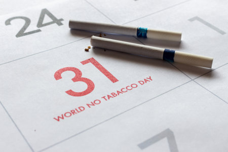 world no tobacco day concept. cigarettes on calendar with soft-focus and over light in the backgroundの写真素材