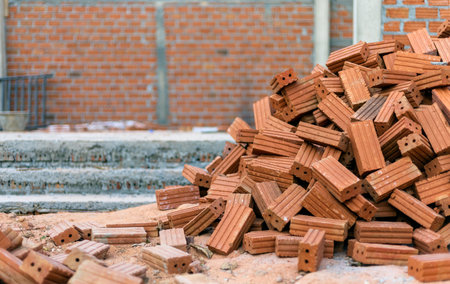 closup group of red bricks on construction site  with soft-focus and over light in the backgroundの写真素材