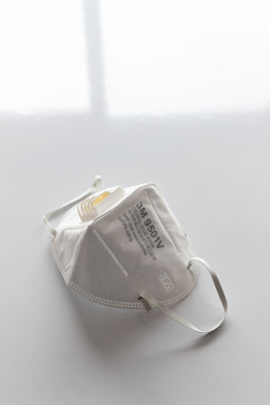 3M N95 air filter mask. personal protective equipment on white table with soft-focus and over light in the backgroundのeditorial素材