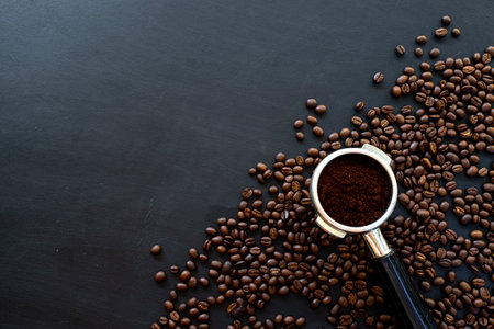 coffee bean on black wooden floor background. top view. space for text