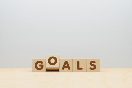 business and education concept. wooden cubes with GOALS word on goal target with copy space. 3D illustrationの写真素材