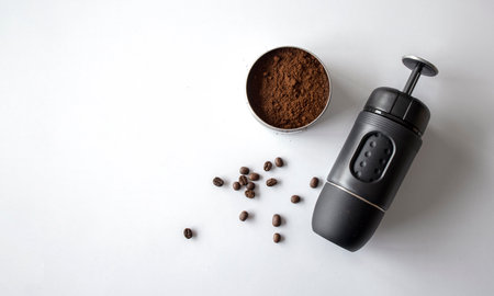 espresso coffee machine, cup and bean on white table background. top view