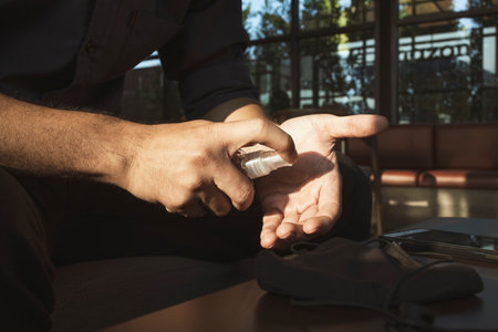 closeup man washing hands with alcohol gel 75% prevent virus and plague infection wihe soft-focus and over light in the backgroundの写真素材