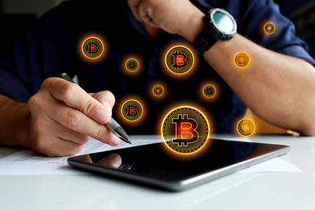 bitcoins fall in laptop. businessmen make money on laptops with soft focus and backlighting....