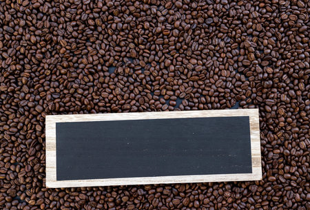 wooden sign, hot coffee and beans on wooden table background. mockup and templates to create greeting, cards, magazines, cover, poster and banners etc. space for text. top view. flat layの写真素材