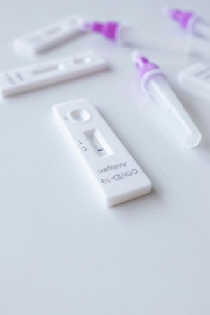 covid-19 positive and negative test result. antigen (ATK) test kitâ onâ whiteâ background. top view. flat layの写真素材