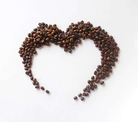 Coffee lover. Coffee beans arranged in a beautiful heart shape on white background.  Festive card for Valentines Day. top view. flat lay. 3D illustrationの写真素材