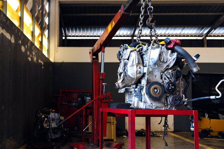 closeup detail of car engine in service center with soft-focus and over light in the background