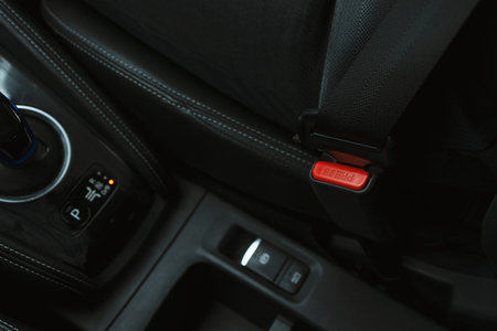 Close-up Men's hand fastens the seat belt of the car while sitting inside the car before driving and...