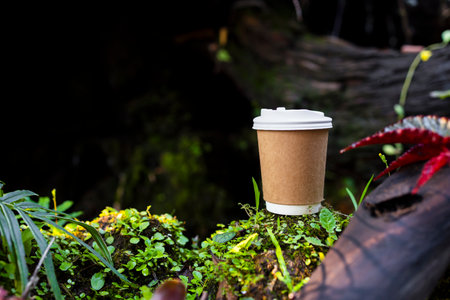 Indulge in the delightful aroma of hot coffee amidst a serene green garden. Experience the perfect blend of nature and relaxation with our inviting cafÃ© sceneの写真素材