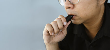 Man Vaping with Electronic Cigarette. The dangers of e-cigarettes