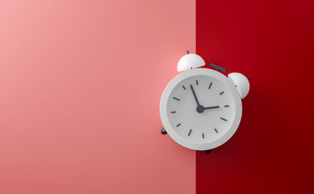 A modern white alarm clock set against a striking red and pink background. Ideal for themes of time,...