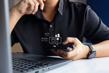 Person using smartphone and laptop receiving new email notifications. Concept of online messaging,...