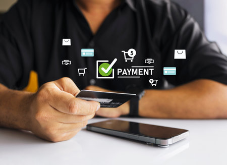Closeup of online payment using credit card and laptop with checkout form and cart icons, concept of...