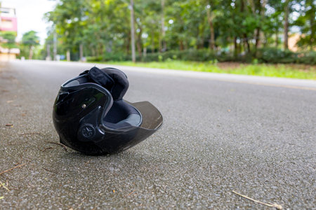 Motorcycle accident with helmet on road and safety reminder Save Life message, concept of road...