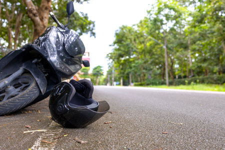 Motorcycle accident with helmet on road and safety reminder Save Life message, concept of road safety and awarenessの写真素材