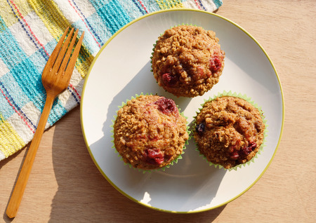 Banana crumble with mix berries cupcake on a plateの写真素材