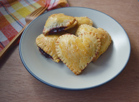 ็Homemade raspberries and lemon pies crust hearts on a plateの写真素材