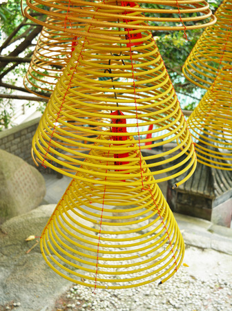 Spiral incense burning for praying Buddha in the templeの写真素材