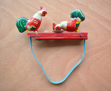 Retro chicken tin toy on wood backgroundの写真素材