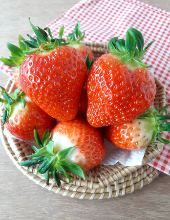 Close up fresh strawberries in a basketの写真素材