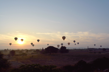 BAGAN, MYANMAR-JANUARY 19, 2017: Sunrise with hot air balloons are flying over the pagodas plain of Bagan, Myanmar.の写真素材