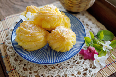 Eclairs in a plate served with tea or coffee