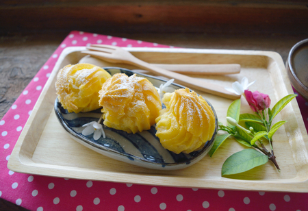 Eclairs in a plate served with tea or coffeeの写真素材