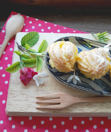 Eclairs in a plate served with tea or coffeeの写真素材