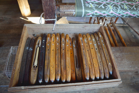 Old wooden Hand loom in a wood box for making fabrics and clothsの写真素材