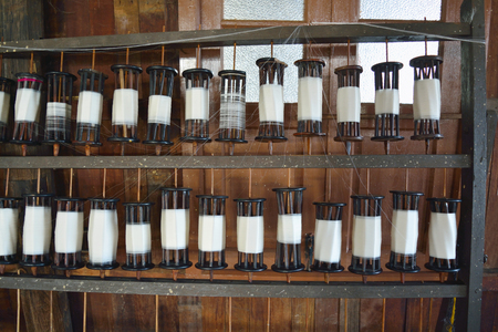 Spools of white thread for making silk or textile productsの写真素材