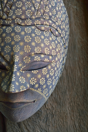 Handmade wood mask on wooden backgroundの写真素材