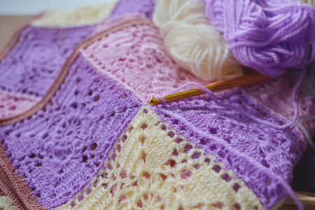 Focusing crochet hook on handmade crochet pattern and yarnsの写真素材