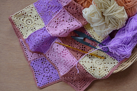 Beautiful handmade Crochet with colorful yarns, crochet hook and scissors in a basketの写真素材