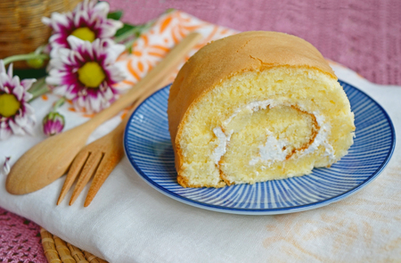 Homemade vanilla cake roll on a plate serve with tea or coffeeの写真素材